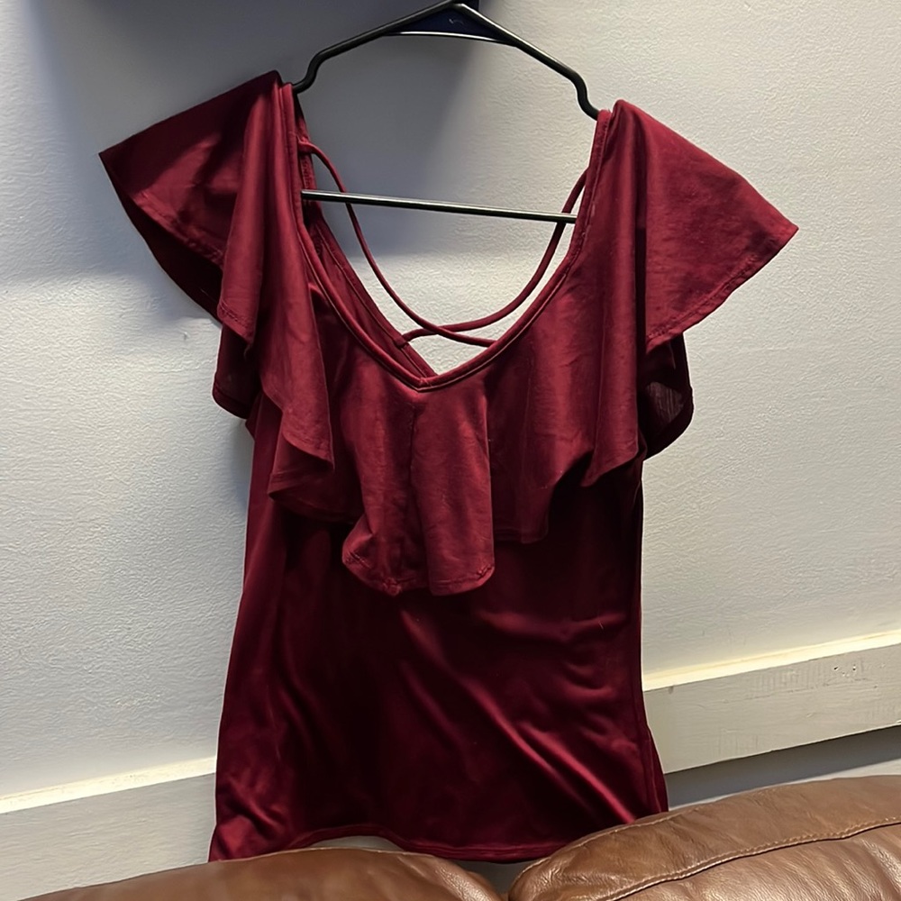 Cranberry ruffled shirt size medium. It’s fitted around the waist.